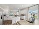 Modern kitchen with island, white cabinetry, and stainless steel appliances at 64 Tributary Way, Fuquay Varina, NC 27526