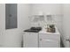 Clean laundry room with washer, dryer, and shelving at 64 Tributary Way, Fuquay Varina, NC 27526