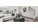 Living room with sectional sofa, coffee table, and view of staircase at 64 Tributary Way, Fuquay Varina, NC 27526