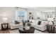 Spacious living room with sectional sofa, large windows and coffee table at 64 Tributary Way, Fuquay Varina, NC 27526