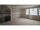Unfinished living room featuring corner cabinets and windows with natural light at 6805 Greystone Dr, Raleigh, NC 27615