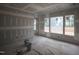 Unfinished living room featuring large windows with natural light at 6805 Greystone Dr, Raleigh, NC 27615