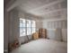Bright living room under construction features a large window providing natural light and exposed drywall at 6805 Greystone Dr, Raleigh, NC 27615