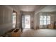 Spacious, light-filled living room under construction with large windows and an arched doorway leading to another room at 6805 Greystone Dr, Raleigh, NC 27615