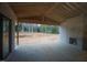 Unfinished covered patio featuring a brick fireplace and a large outdoor space at 6805 Greystone Dr, Raleigh, NC 27615