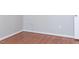 Bedroom with wood flooring and access to upper level at 7126 Longstreet Dr # A, Raleigh, NC 27615