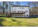 Expansive back exterior view showing a two-story deck and a lush green yard, perfect for outdoor enjoyment and relaxation at 811 Oxbow Crossing Rd, Chapel Hill, NC 27516