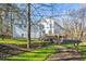 The back exterior of this home features a two-story deck and a tiered yard. The deck is ideal for outdoor entertaining at 811 Oxbow Crossing Rd, Chapel Hill, NC 27516
