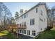 The back exterior view of this home highlights the expansive deck, perfect for outdoor entertaining and relaxation at 811 Oxbow Crossing Rd, Chapel Hill, NC 27516