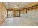 Unfinished basement featuring concrete floors, exposed beams, and a walkout door, offering a blank canvas for customization at 811 Oxbow Crossing Rd, Chapel Hill, NC 27516