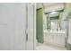 Bathroom with a glass-enclosed shower, white vanity, and green walls for a refreshing ambiance at 811 Oxbow Crossing Rd, Chapel Hill, NC 27516
