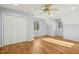Spacious bedroom with hardwood floors, white closet doors, and plenty of natural light from two windows at 811 Oxbow Crossing Rd, Chapel Hill, NC 27516