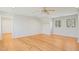 Large bedroom with beautiful hardwood floors, a ceiling fan, and ample natural light from multiple windows at 811 Oxbow Crossing Rd, Chapel Hill, NC 27516