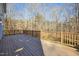 View of wooden deck with wood railings showcasing a tranquil view of the surrounding trees, creating a serene outdoor space at 811 Oxbow Crossing Rd, Chapel Hill, NC 27516