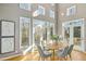 Bright dining area with light wood floors, neutral walls, and multiple windows at 811 Oxbow Crossing Rd, Chapel Hill, NC 27516