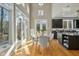 Sunlit dining room featuring wood floors, high ceilings, and adjacent kitchen area at 811 Oxbow Crossing Rd, Chapel Hill, NC 27516
