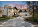 Beautiful two-story home with white exterior and ample parking in the driveway during dusk at 811 Oxbow Crossing Rd, Chapel Hill, NC 27516