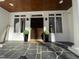 Stylish front door with black slate tile and decorative plants on the entryway porch at 811 Oxbow Crossing Rd, Chapel Hill, NC 27516