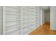 Hallway features built-in floor to ceiling shelving and hardwood floors at 811 Oxbow Crossing Rd, Chapel Hill, NC 27516