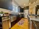 Modern kitchen featuring black cabinets, stainless steel appliances, and granite countertops at 811 Oxbow Crossing Rd, Chapel Hill, NC 27516