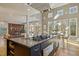 Kitchen island with granite countertop, stainless steel appliances, and adjacent dining area at 811 Oxbow Crossing Rd, Chapel Hill, NC 27516