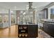 Open-concept kitchen with dark cabinets, granite island, and seamless flow to the dining area at 811 Oxbow Crossing Rd, Chapel Hill, NC 27516