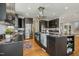 Spacious kitchen with a large center island, black cabinets, and modern lighting at 811 Oxbow Crossing Rd, Chapel Hill, NC 27516