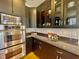 Kitchen corner with glass cabinets, granite countertops, and stainless steel microwave and ovens at 811 Oxbow Crossing Rd, Chapel Hill, NC 27516