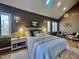 Warm and cozy bedroom showcasing stylish sconces and natural light from many windows at 811 Oxbow Crossing Rd, Chapel Hill, NC 27516