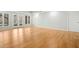 Open room with beautiful hardwood floors, recessed lighting, and natural light streaming through the glass doors at 811 Oxbow Crossing Rd, Chapel Hill, NC 27516