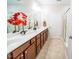 Double vanity bathroom with updated cabinetry and neutral tile flooring at 135 Abbey View Way, Cary, NC 27519