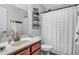 Bright bathroom with a white shower curtain and wood vanity at 151 Crosscreek Ln, Angier, NC 27501