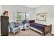 Cozy bedroom with a twin bed, armchair, and large window at 151 Crosscreek Ln, Angier, NC 27501