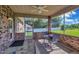 Screened porch with table, chairs and view of backyard at 151 Crosscreek Ln, Angier, NC 27501