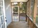 Relaxing screened porch with wooden floor and access to backyard at 165 Millwood Dr, Clayton, NC 27527