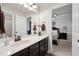 Bright bathroom featuring double doors, white countertops, and dark cabinets at 320 Westgrove Ct, Durham, NC 27703