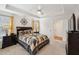 Spacious bedroom featuring a tray ceiling, neutral walls, and a decorative wall hanging at 320 Westgrove Ct, Durham, NC 27703