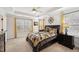 Bedroom featuring neutral walls, two windows with yellow drapes, and two dark-stained nightstands at 320 Westgrove Ct, Durham, NC 27703