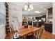 A dining table sits adjacent to an open kitchen and living area at 320 Westgrove Ct, Durham, NC 27703
