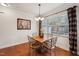 Dining area featuring a wood table, iron chairs, chandelier, and window at 320 Westgrove Ct, Durham, NC 27703