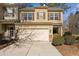 Tan two-story townhome with a double-car garage and landscaping at 320 Westgrove Ct, Durham, NC 27703