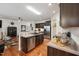 Modern kitchen features stainless steel appliances, dark wood cabinets, and a central island with sink at 320 Westgrove Ct, Durham, NC 27703