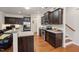 Bright kitchen features stainless steel appliances, dark wood cabinetry, and hardwood floors at 320 Westgrove Ct, Durham, NC 27703