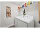 Functional laundry room with white washer and dryer, wire shelving, and painted trim at 320 Westgrove Ct, Durham, NC 27703