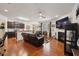 Open-concept living space featuring dark kitchen cabinets, leather sofas, and a fireplace at 320 Westgrove Ct, Durham, NC 27703