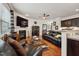 Comfortable living room featuring a fireplace, TV, and leather sofas at 320 Westgrove Ct, Durham, NC 27703