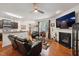 Open living area with kitchen, dining space, leather sofas, and a fireplace at 320 Westgrove Ct, Durham, NC 27703