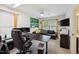 Office space with a comfortable leather sofa, golf course wall art, and functional desk at 320 Westgrove Ct, Durham, NC 27703