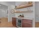 Stylish bar area with open shelving, a wine refrigerator, and elegant countertop at 3304 Cheswick Dr, Raleigh, NC 27609