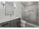 Elegant bathroom featuring a gray vanity, large mirror, and glass-enclosed shower at 3304 Cheswick Dr, Raleigh, NC 27609